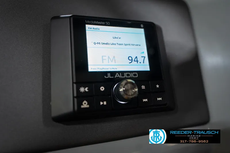 Slide: The Image of Steering wheel of 2020 Harris Solstice boat, featuring chrome and leather details. - 32