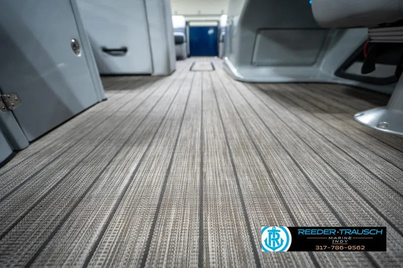 Slide: The Image of 2020 Harris Solstice boat cup holders with blue LED lighting and Reeder-Trausch Marine logo. - 47