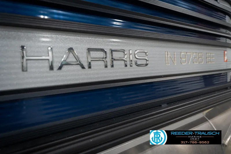 Slide: The Image of 2020 Harris Solstice 250 boat with blue exterior and Reeder-Trausch Marine logo. - 49