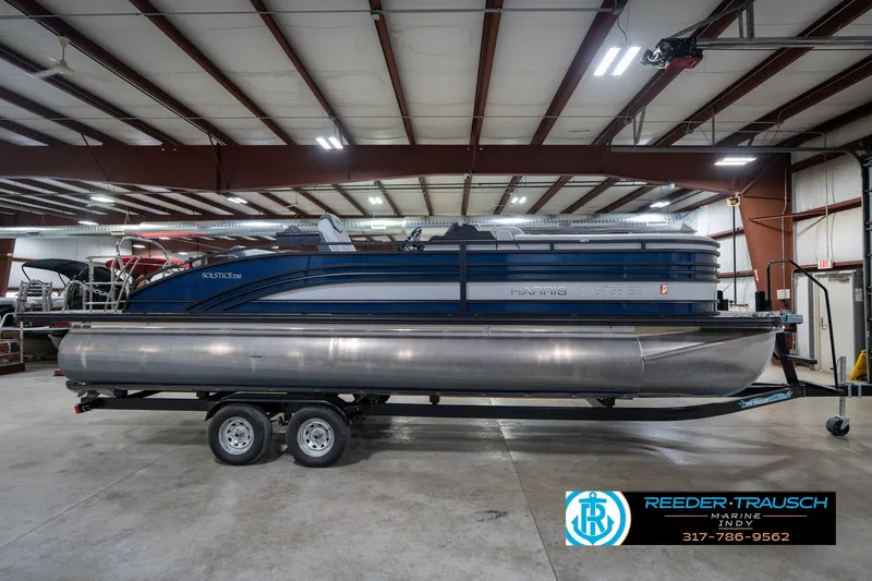 Slide: The Image of 2020 Harris Solstice pontoon boat on trailer in indoor showroom. - 5