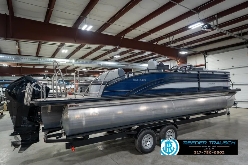 Slide: The Image of 2020 Harris Solstice pontoon boat in indoor showroom on trailer. - 6