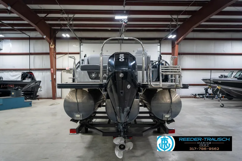 Slide: The Image of 2020 Harris Solstice pontoon boat in showroom, displayed on trailer. - 7