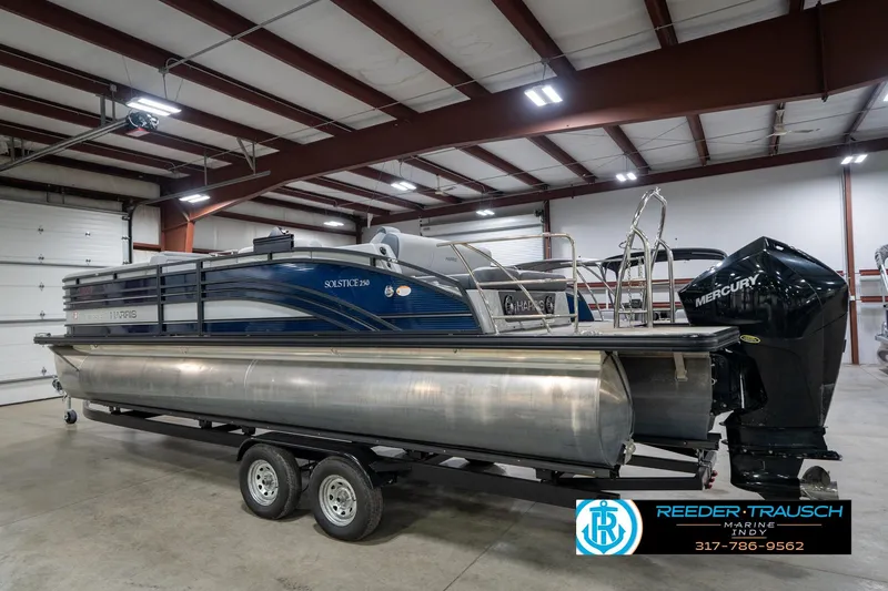 Slide: The Image of 2020 Harris Solstice pontoon boat with 200 HP engine in a showroom. - 8