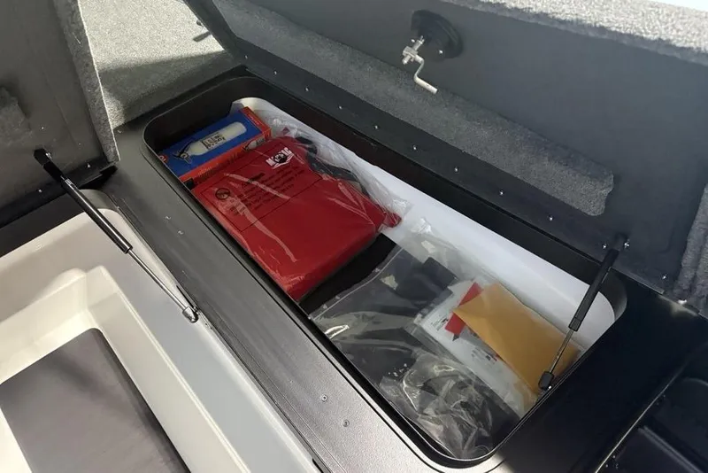 Slide: The Image of Storage compartment of 2026 Skeeter ZXR20 SE boat with organized gear and equipment. - 11