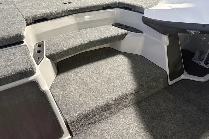 Slide: The Image of 2026 Skeeter ZXR20 SE boat interior with carpeted steps and seating area. - 15