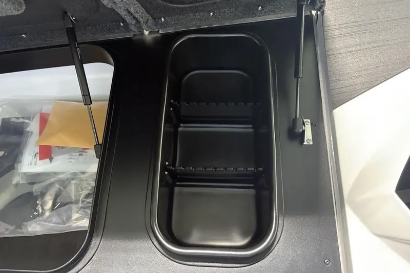 Slide: The Image of 2026 Skeeter ZXR20 SE storage compartment with hydraulic lift and organized interior. - 17