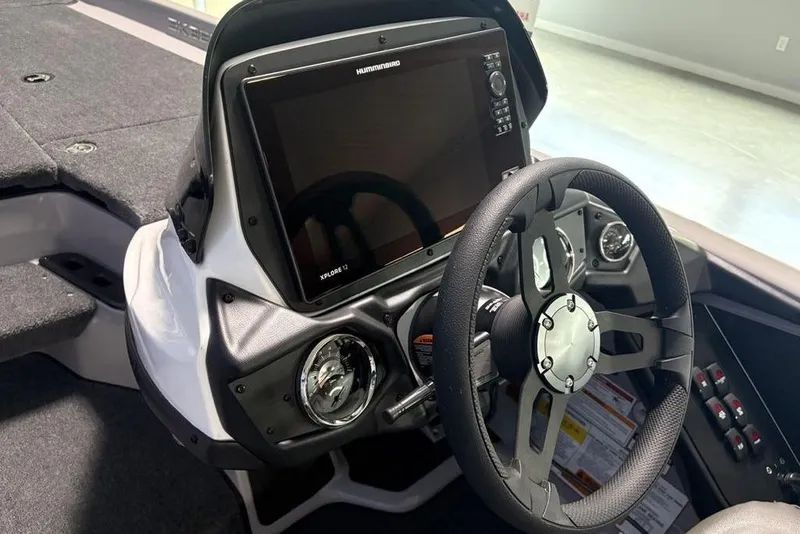 Slide: The Image of 2026 Skeeter ZXR20 SE boat dashboard with steering wheel and advanced navigation display. - 21