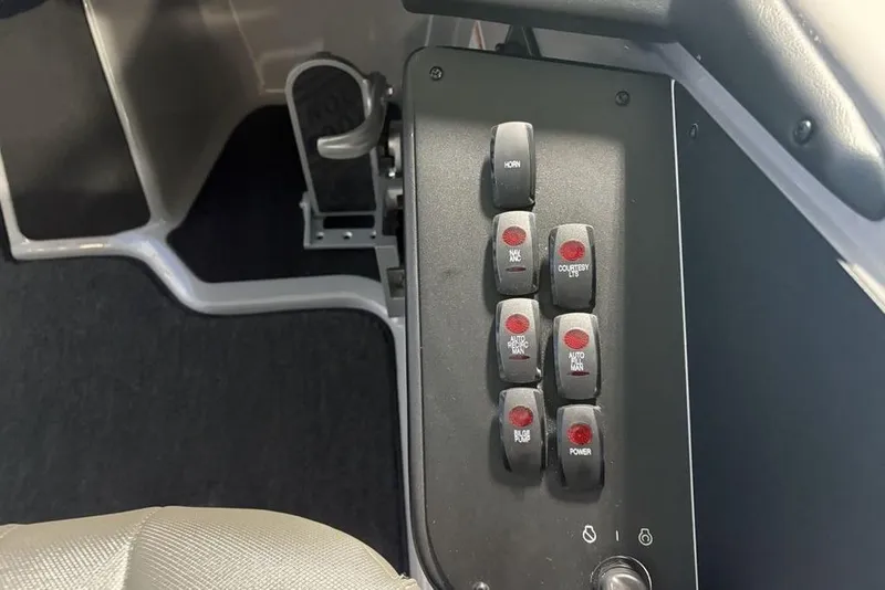 Slide: The Image of Control panel of 2026 Skeeter ZXR20 SE boat with labeled switches and foot pedal. - 23