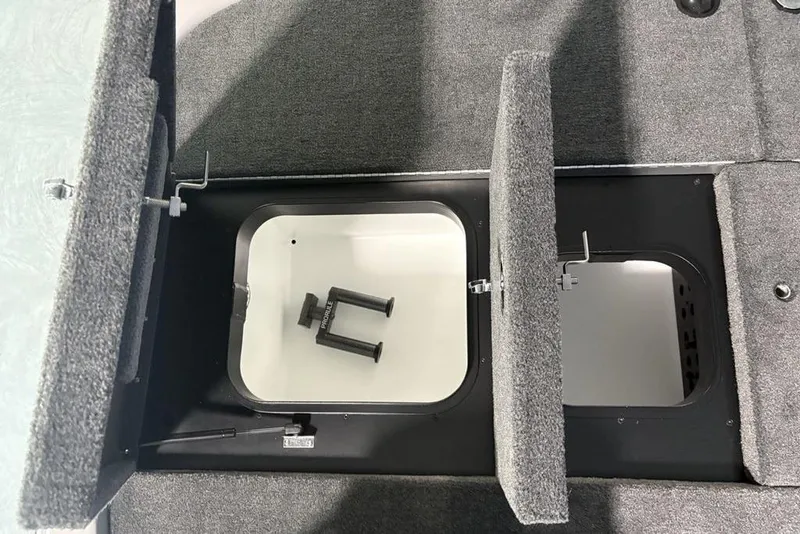 Slide: The Image of Storage compartments in a 2026 Skeeter ZXR20 SE boat, featuring carpeted lids and interior space. - 31