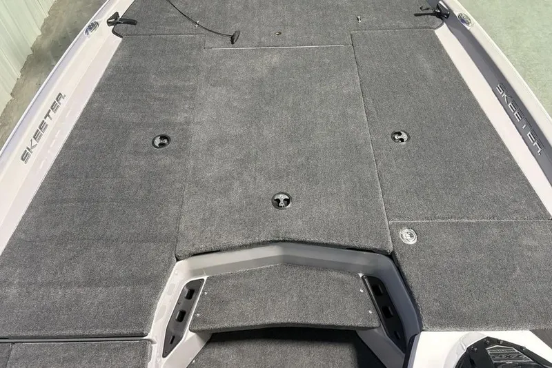 Slide: The Image of 2026 Skeeter ZXR20 SE boat deck with gray carpet and storage compartments. - 8