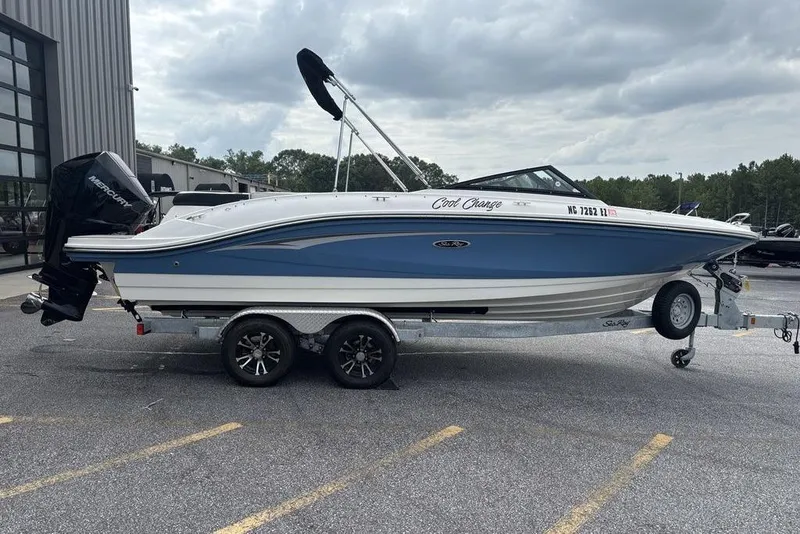 Slide: The Image of 2023 Sea Ray SPX 210 Outboard boat on trailer, parked outdoors. - 10