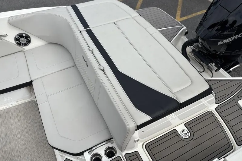 Slide: The Image of 2023 Sea Ray SPX 210 Outboard boat interior with cushioned seating and Mercury outboard motor. - 14