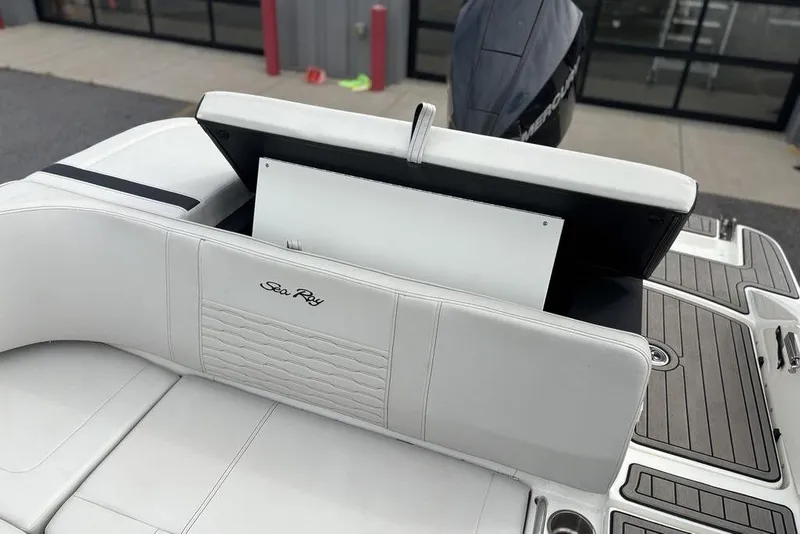 Slide: The Image of 2023 Sea Ray SPX 210 Outboard boat interior with open storage compartment. - 18