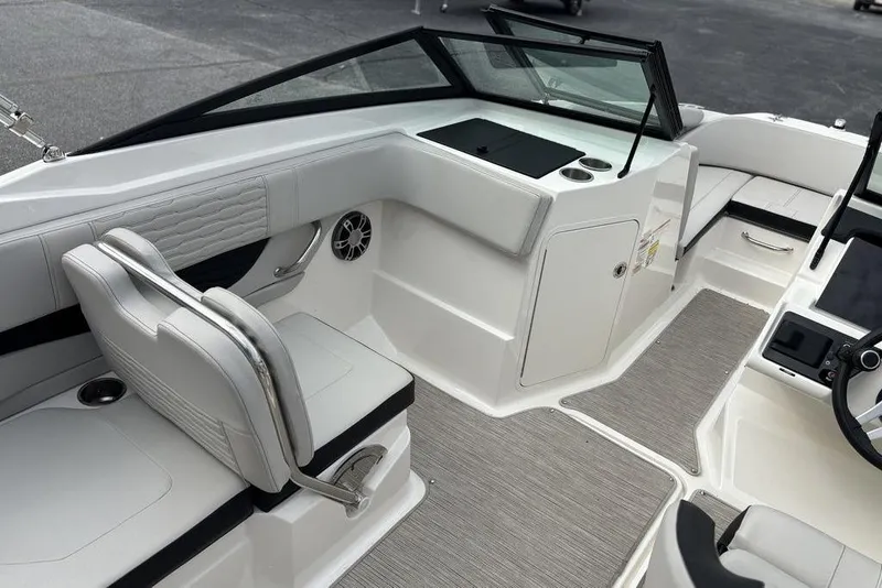 Slide: The Image of 2023 Sea Ray SPX 210 Outboard interior, featuring sleek white seating and modern dashboard design. - 21