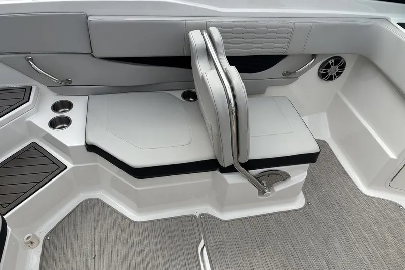 Slide: The Image of 2023 Sea Ray SPX 210 Outboard interior seating with cup holders and speaker. - 24