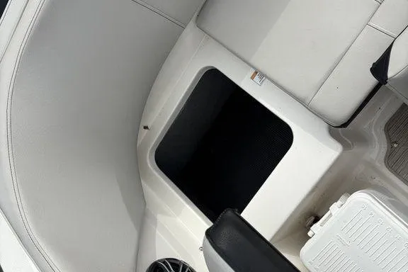 Slide: The Image of 2023 Sea Ray SPX 210 Outboard interior with seating and storage compartment. - 26