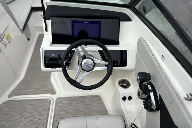 Slide: The Image of 2023 Sea Ray SPX 210 Outboard boat dashboard with steering wheel and controls. - 27