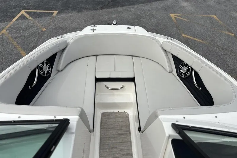 Slide: The Image of 2023 Sea Ray SPX 210 Outboard boat interior with white seating and speakers. - 28