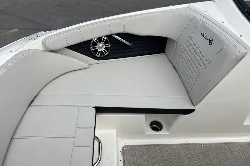 Slide: The Image of 2023 Sea Ray SPX 210 Outboard boat interior with cushioned seating and speaker. - 29