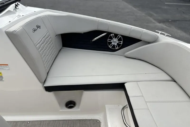 Slide: The Image of 2023 Sea Ray SPX 210 Outboard boat interior with cushioned seating and speaker. - 30