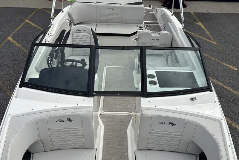 Slide: The Image of 2023 Sea Ray SPX 210 Outboard boat interior with seating and steering wheel. - 31