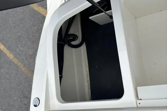 Slide: The Image of 2023 Sea Ray SPX 210 Outboard storage compartment, white interior, viewed from above. - 32