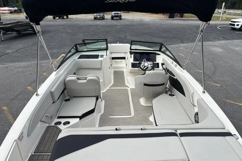 Slide: The Image of 2023 Sea Ray SPX 210 Outboard boat interior with seating and steering wheel. - 5