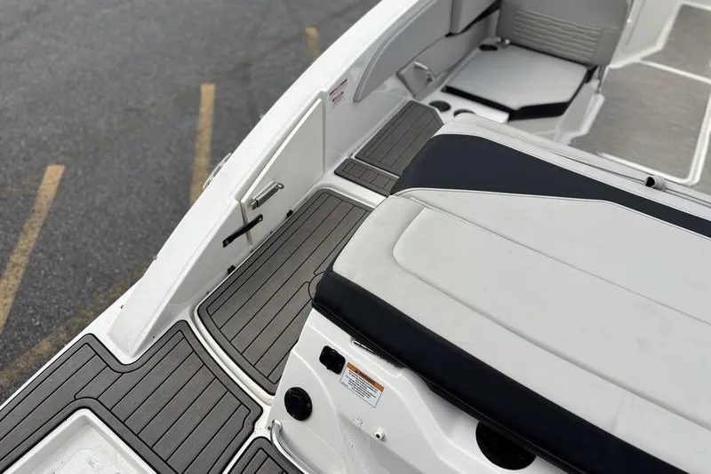 Slide: The Image of 2023 Sea Ray SPX 210 Outboard boat interior with sleek seating and deck design. - 7