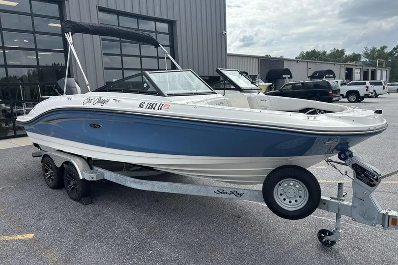 Slide: The Image of 2023 Sea Ray SPX 210 Outboard boat on trailer, parked outside dealership. - 8