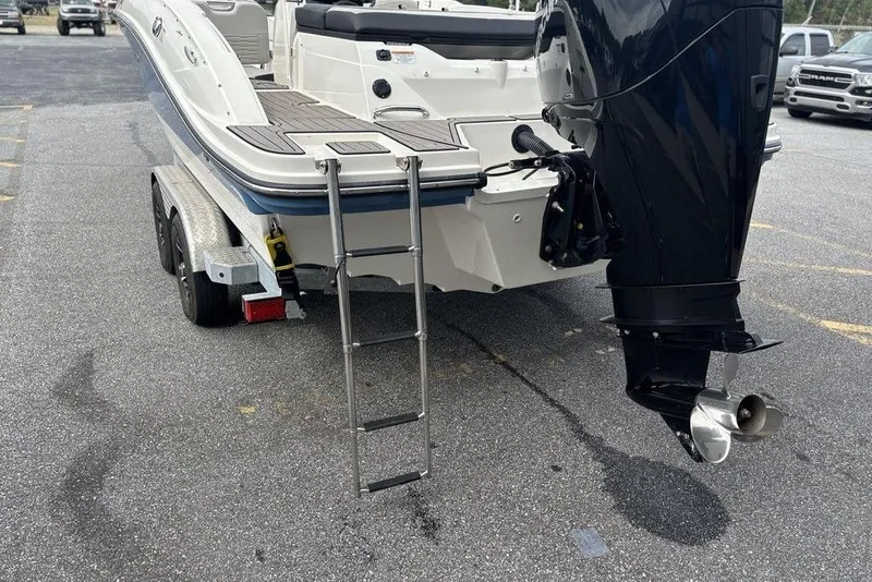 Slide: The Image of 2023 Sea Ray SPX 210 Outboard boat on trailer, featuring rear ladder and powerful outboard motor. - 9