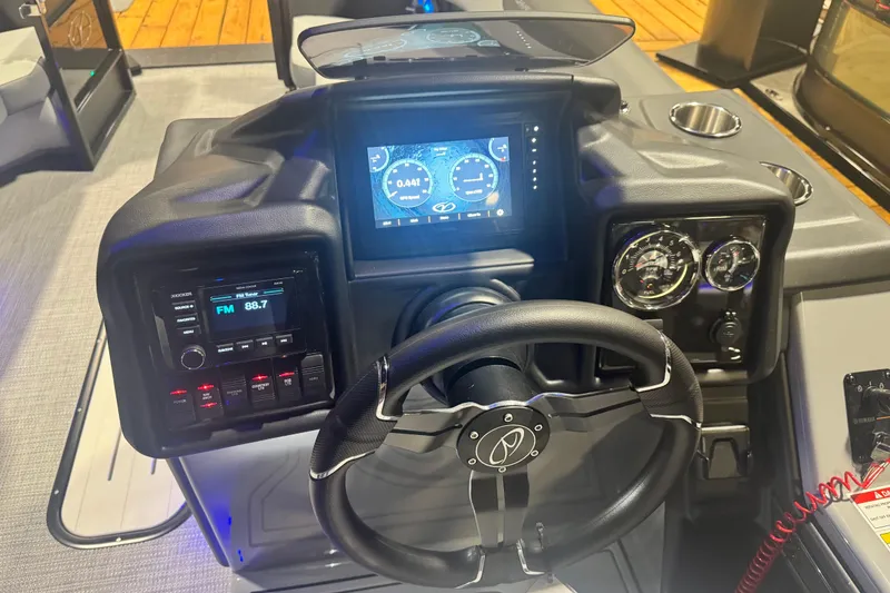 Slide: The Image of 2026 Veranda Relax VR235RC boat dashboard with steering wheel, digital display, and control panel. - 10
