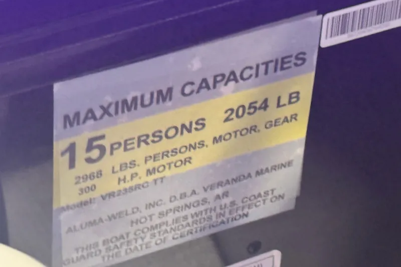 Slide: The Image of Capacity label for Veranda Relax VR235RC, 2026 model, 15 persons, 2054 lbs, 300 HP motor. - 11