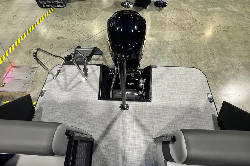 Slide: The Image of 2026 Veranda Relax VR235RC boat deck with motor and seating, displayed indoors. - 13