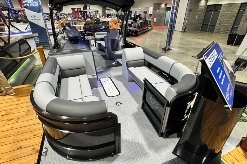 Slide: The Image of 2026 Veranda Relax VR235RC pontoon boat with luxurious seating at a boat show display. - 2