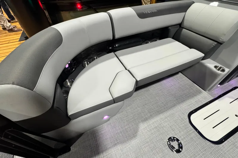 Slide: The Image of 2026 Veranda Relax VR235RC boat interior with plush seating and cup holders. - 4