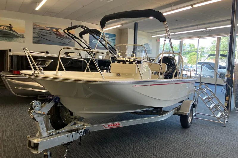 The Image of 2026 Boston Whaler 170 Montauk boat displayed indoors on a trailer. - 0