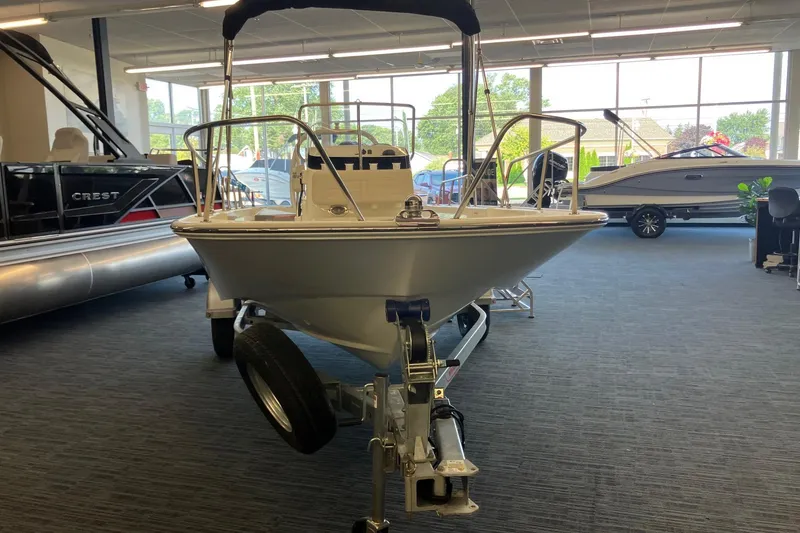 Slide: The Image of 2026 Boston Whaler 170 Montauk boat displayed indoors on a trailer. - 2