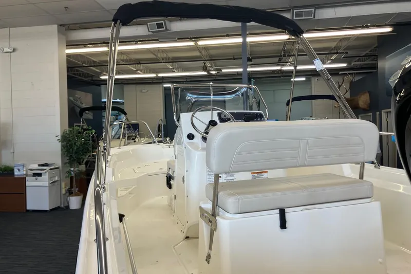 Slide: The Image of 2026 Boston Whaler 170 Montauk boat interior with seating and steering console. - 4