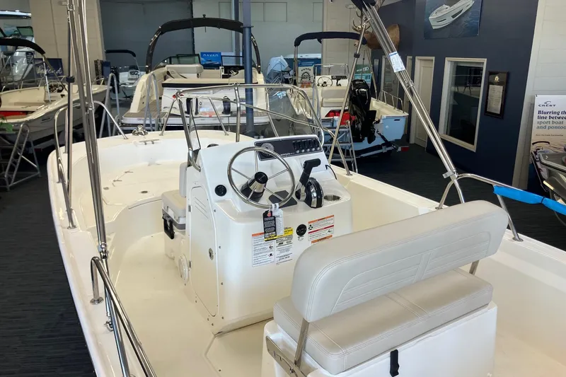 Slide: The Image of 2026 Boston Whaler 170 Montauk boat interior with steering console in showroom. - 5