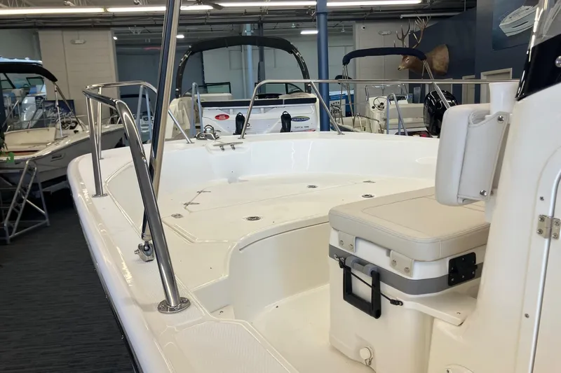 Slide: The Image of 2026 Boston Whaler 170 Montauk boat interior, showroom display with seating and railing. - 7