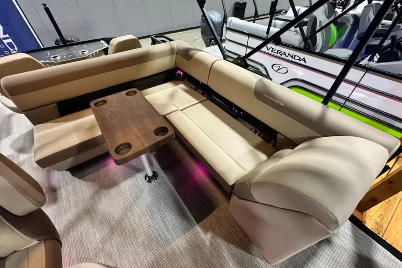 Slide: The Image of Luxurious seating area on 2026 Veranda Relax VR235F2 pontoon boat with wooden table. - 9