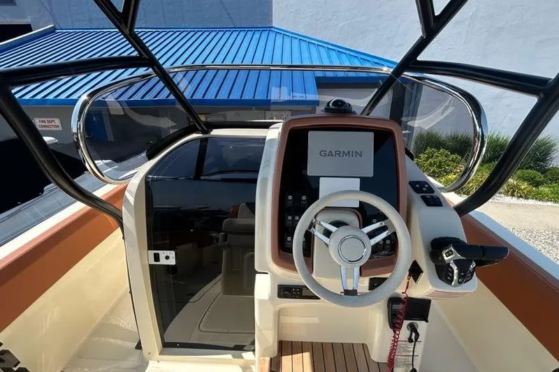 Slide: The Image of 2024 Capoforte FX270 boat helm with Garmin navigation system and modern steering wheel. - 10