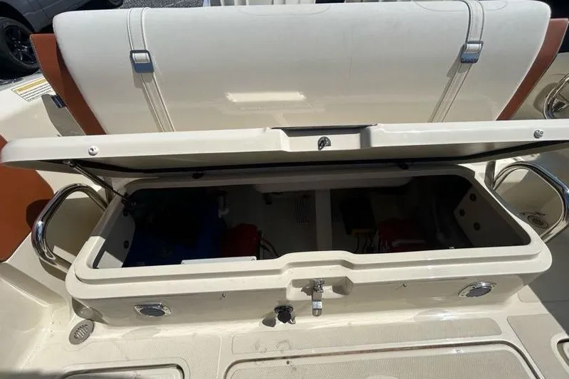 Slide: The Image of 2024 Capoforte FX270 boat storage compartment with open lid, showcasing interior space. - 13