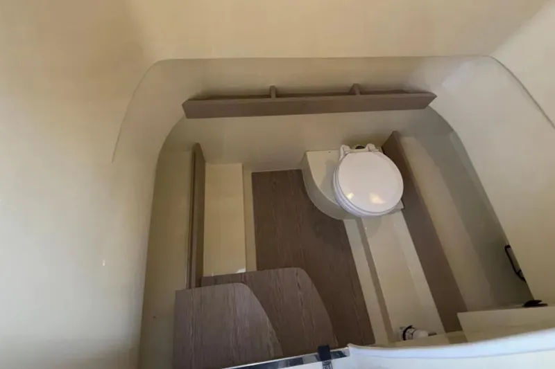 Slide: The Image of 2024 Capoforte FX270 boat interior bathroom with modern fixtures and wooden accents. - 19