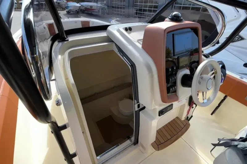 Slide: The Image of 2024 Capoforte FX270 boat helm with steering wheel and cabin entrance. - 20