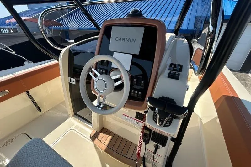 Slide: The Image of 2024 Capoforte FX270 boat cockpit with Garmin navigation system and modern steering wheel. - 9