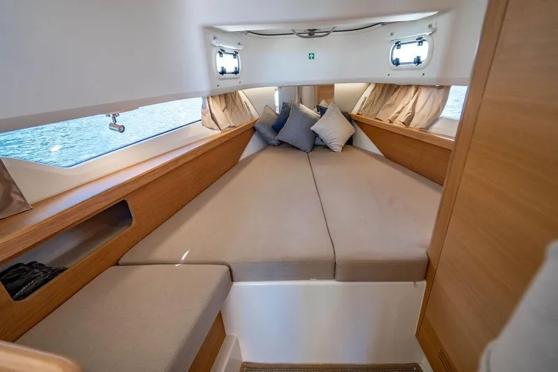 Slide: The Image of Cozy cabin interior of 2023 Nimbus Tender 11 with cushions and wooden accents. - 24