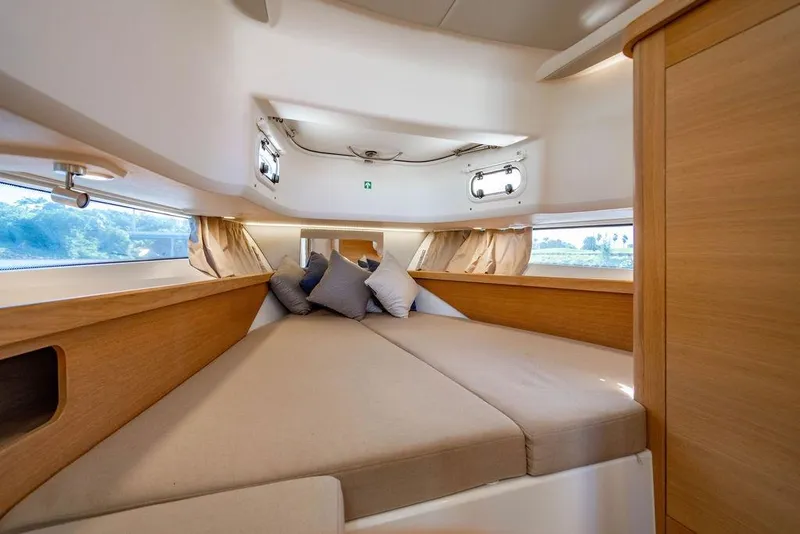 Slide: The Image of Luxurious interior cabin of 2023 Nimbus Tender 11 with cozy bedding and wooden accents. - 25