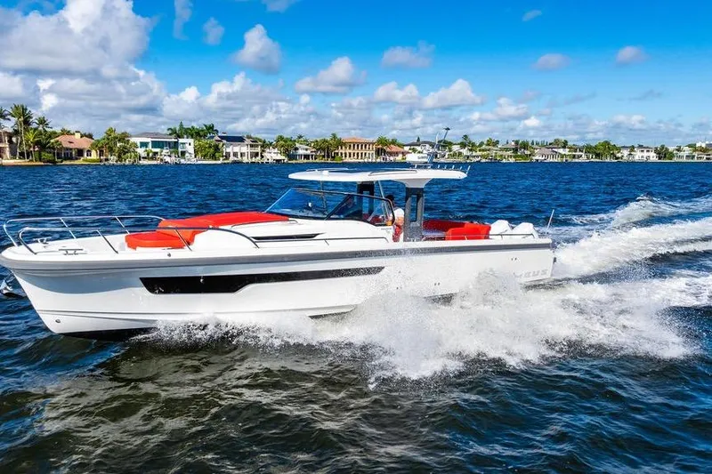 Slide: The Image of 2023 Nimbus Tender 11 cruising on a sunny day, with vibrant red seating. - 28