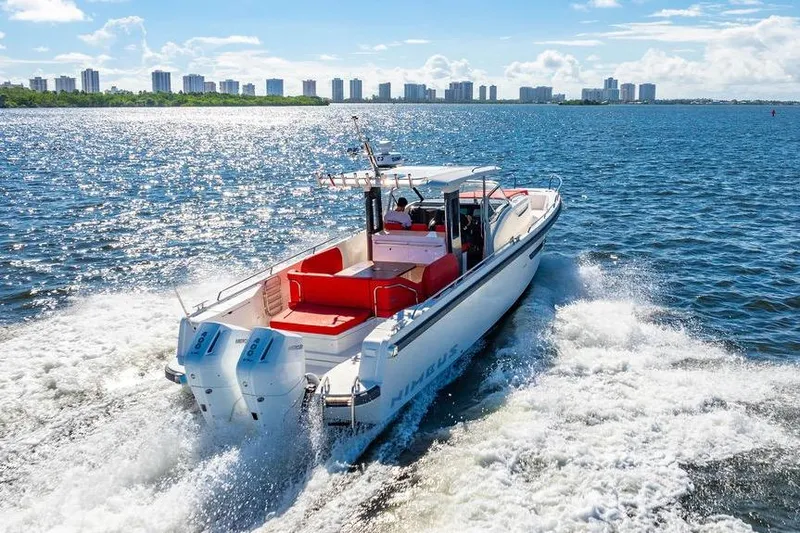 Slide: The Image of 2023 Nimbus Tender 11 cruising on a sunny day with city skyline in background. - 31